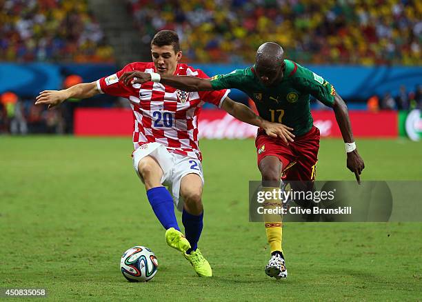 Mateo Kovacic of Croatia controls the ball against Stephane Mbia of Cameroon during the 2014 FIFA World Cup Brazil Group A match between Cameroon and...