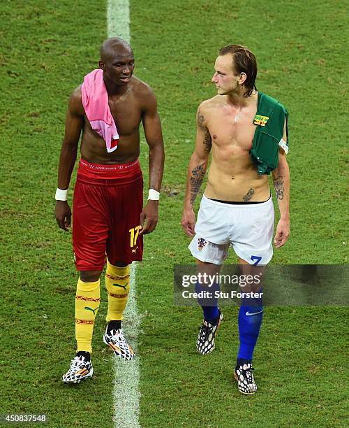 Stephane Mbia of Cameroon and Ivan Rakitic of Croatia walk off the field after Croatia's 4-0 win during the 2014 FIFA World Cup Brazil Group A match...