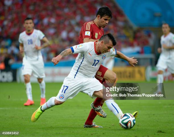 Gary Medel of Chile is challenged by Diego Costa of Spain during the 2014 FIFA World Cup Brazil Group B match between Spain and Chile at Maracana on...
