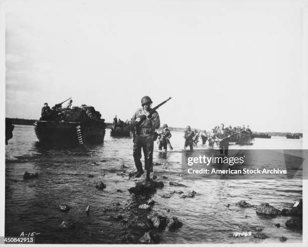 Soldiers of the 112th Cavalry Regiment, making an amphibious beach landing at Woodlark Island, as part of Operation Chronicle during World War Two,...