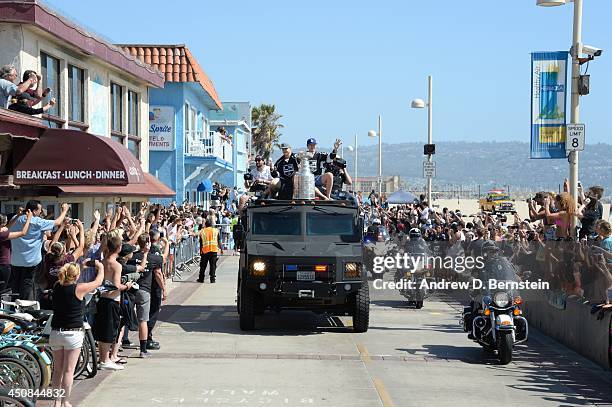 Dustin Brown and Tyler Toffoli of the Los Angeles Kings wave to fans during the Los Angeles Kings South Bay Victory Parade on June 18, 2014 in...