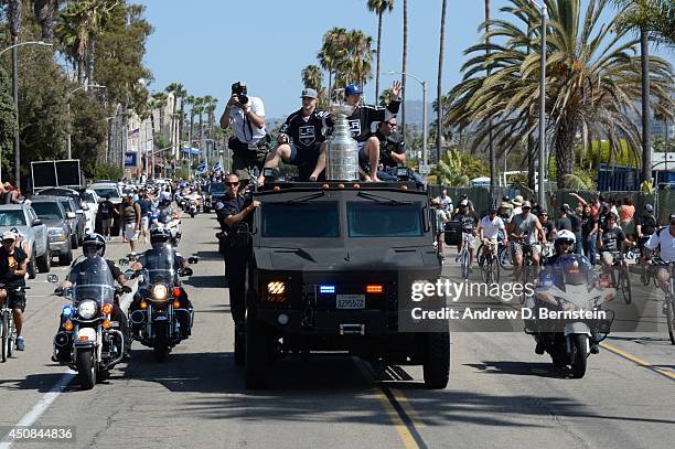 Dustin Brown and Tyler Toffoli of the Los Angeles Kings sit on a truck with the Stanley Cup during the Los Angeles Kings South Bay Victory Parade on...