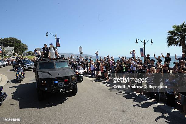 Dustin Brown and Tyler Toffoli of the Los Angeles Kings sit on a truck with the Stanley Cup during the Los Angeles Kings South Bay Victory Parade on...