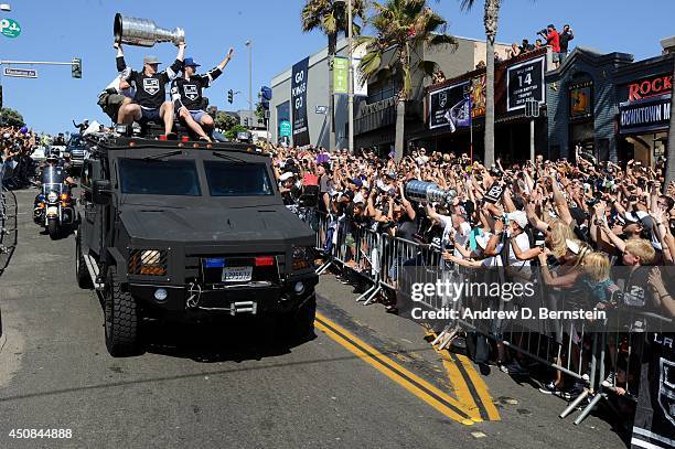 Dustin Brown of the Los Angeles Kings hoists the Stanley Cup and Tyler Toffoli waves to the crowd during the Los Angeles Kings South Bay Victory...