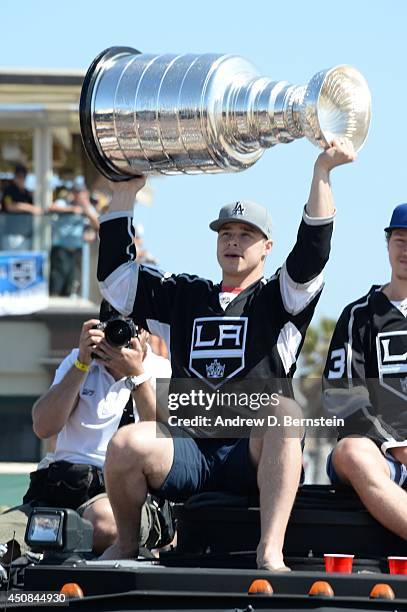 Dustin Brown of the Los Angeles Kings hoists the Stanley Cup during the Los Angeles Kings South Bay Victory Parade on June 18, 2014 in Hermosa Beach,...