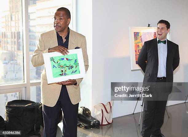 Eriq La Salle receives a gift from the Bronx Charter School For The Arts at their Annual Art Auction at the Glass Houses on June 18, 2014 in New York...