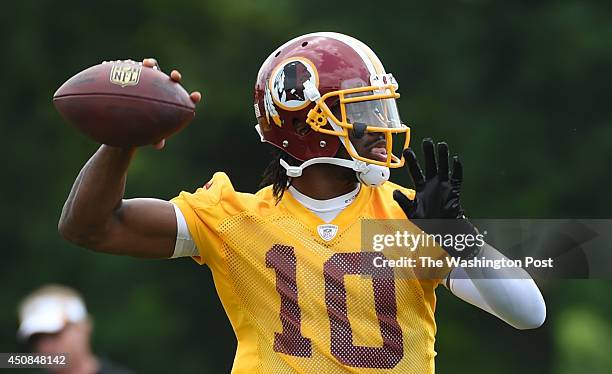 June 11: Washington Redskins quarterback Robert Griffin III throws during their final round of organized team activities on June 11, 2014 in Ashburn,...