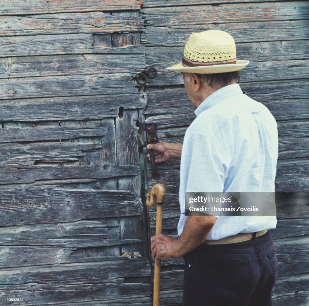 Senior man in front of a traditional door