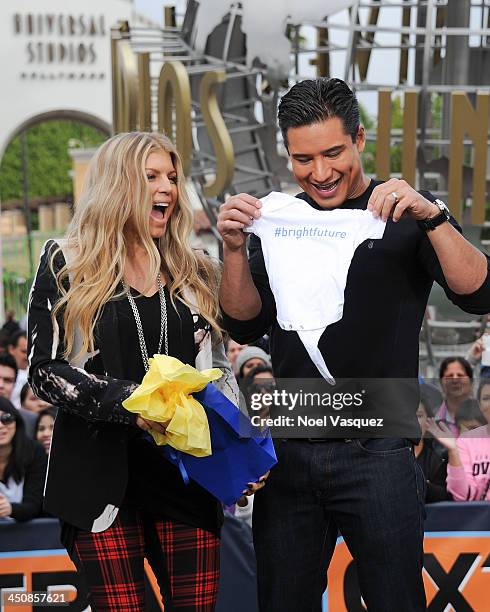 Fergie and Mario Lopez visit "Extra" at Universal Studios Hollywood on November 20, 2013 in Los Angeles, California.