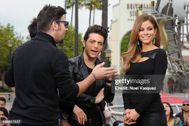 Il Volo sing to Maria Menounos at "Extra" at Universal Studios Hollywood on November 20, 2013 in Los Angeles, California.