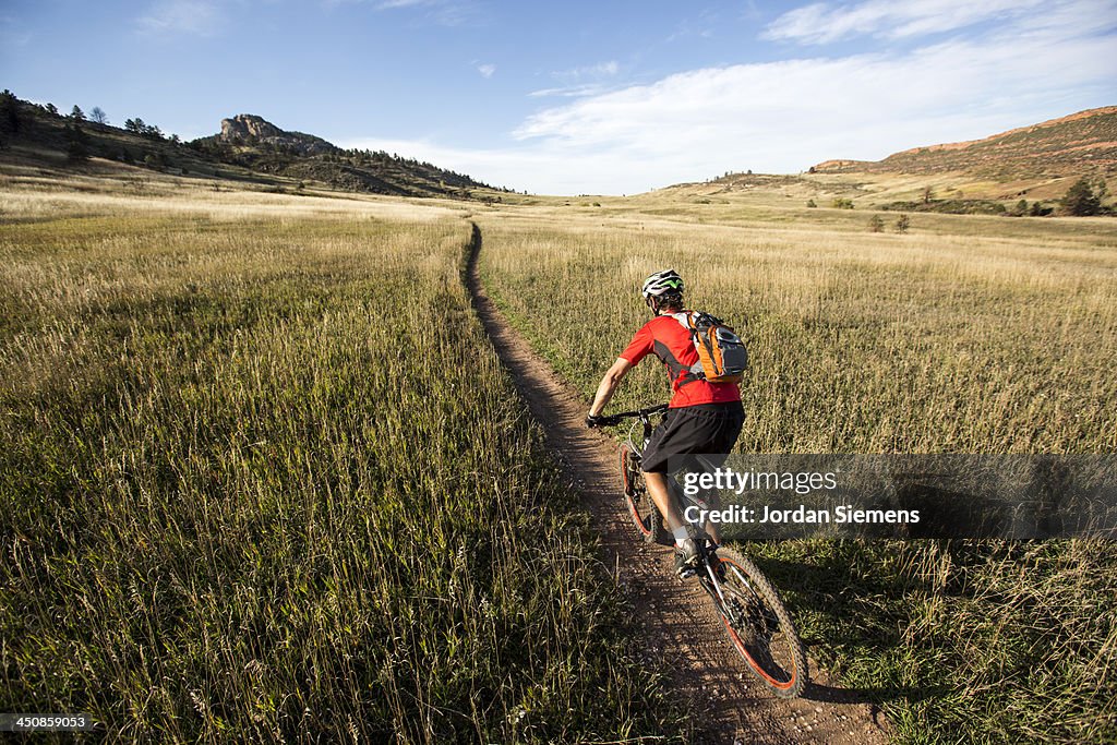 Man biking on a dirt path.