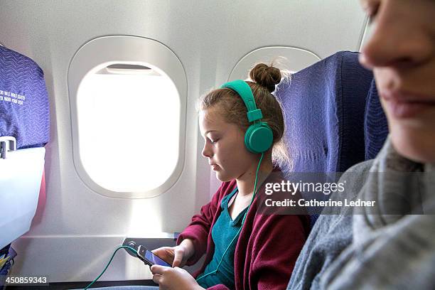 girl on plane listening to music with headphones - woman airplane headphones bildbanksfoton och bilder