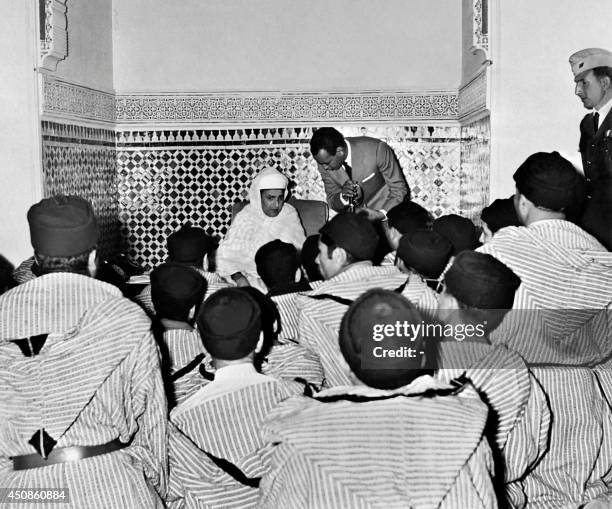 The Sultan of Morocco Muhammad ibn Yousuf and his son Prince Moulay Hassan II , chief of staff of the Moroccan army, meet with tribal chiefs, on...