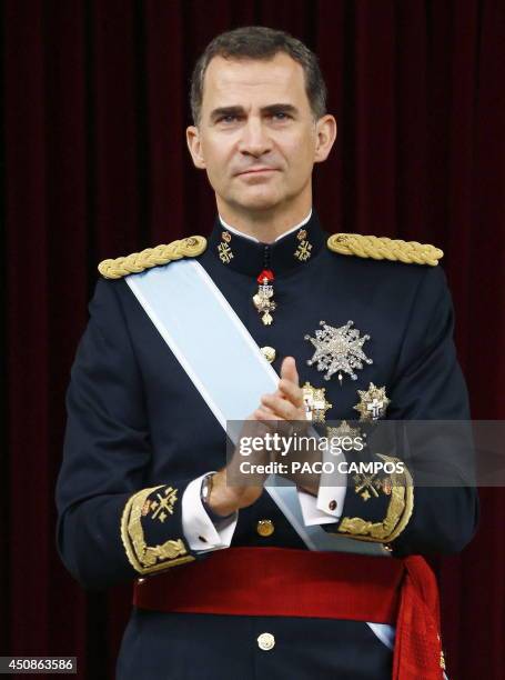Spain's King Felipe VI claps at the Congress of Deputies, Spain's lower House in Madrid on June 19, 2014 for a swearing in ceremony of Spain's new...
