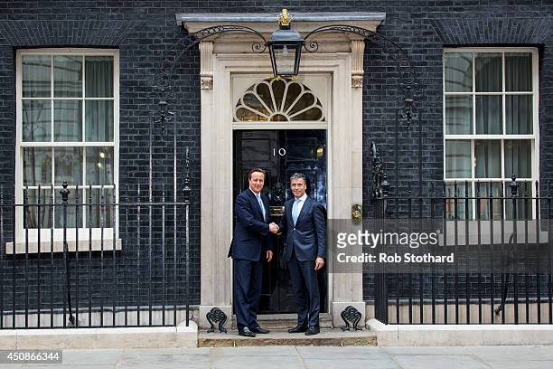 British Prime Minister, David Cameron, greets NATO Secretary General, Anders Fogh Rasmussen, at 10 Downing Street on June 19, 2014 in London,...