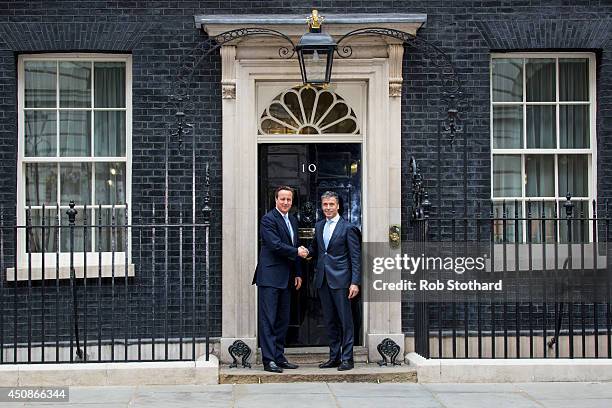 British Prime Minister, David Cameron, greets NATO Secretary General, Anders Fogh Rasmussen, at 10 Downing Street on June 19, 2014 in London,...