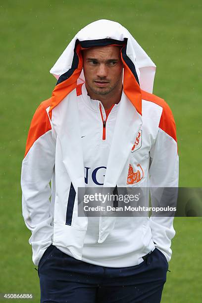 Wesley Sneijder shelters from the rain during the Netherlands training session at the 2014 FIFA World Cup Brazil held at the Estadio Jose Bastos...