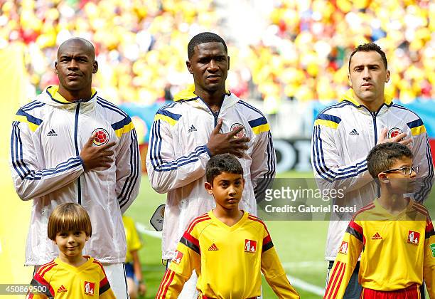 Victor Ibarbo, Cristian Zapata and James Rodriguez of Colombia sing the National Anthem prior to the 2014 FIFA World Cup Brazil Group C match between...
