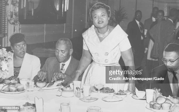 Mamie Bradley, mother of lynched teenager Emmett Till, stands with her father John Carson and the reporter who covered the Emmett Till trial, Jimmy...