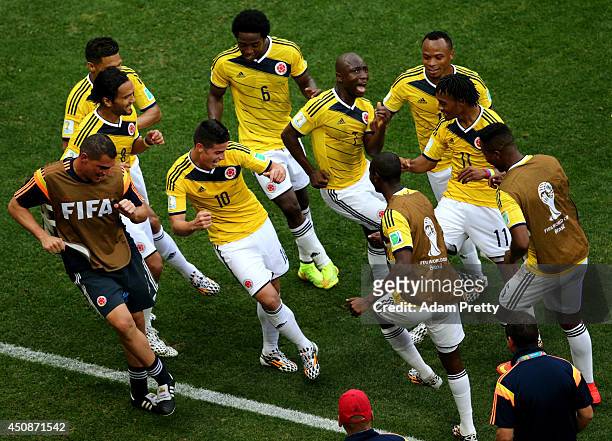 James Rodriguez of Colombia celebrates by dancing with teammates after scoring his team's first goal during the 2014 FIFA World Cup Brazil Group C...