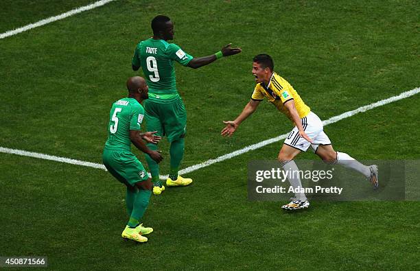 James Rodriguez of Colombia celebrates scoring his team's first goal as Didier Zokora and Cheick Tiote of the Ivory Coast look on during the 2014...