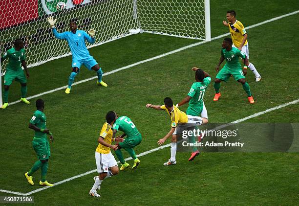 James Rodriguez of Colombia scores his team's first goal on a header past goalkeeper Boubacar Barry of the Ivory Coast during the 2014 FIFA World Cup...