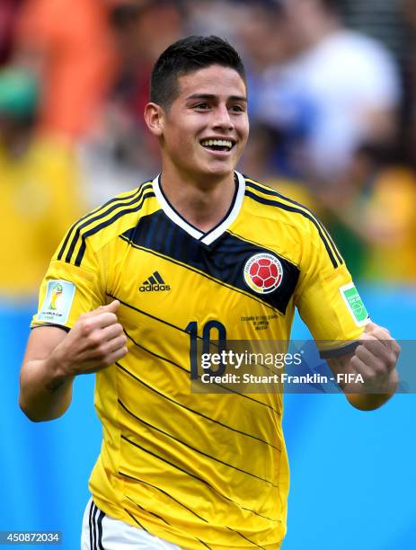 James Rodriguez of Colombia celebrates his team's second goal by Juan Fernando Quintero during the 2014 FIFA World Cup Brazil Group C match between...