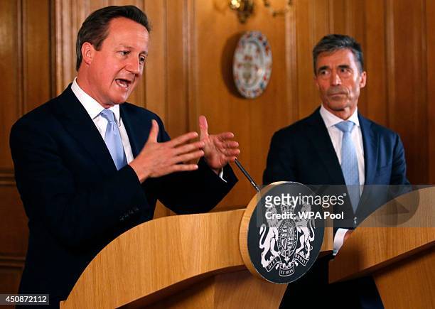 Britain's Prime Minister David Cameron and NATO Secretary-General Anders Fogh Rasmussen hold a joint news conference in Downing Street on June 19,...