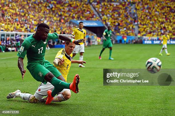 Serge Aurier of the Ivory Coast dribbles past Santiago Arias of Colombia during the 2014 FIFA World Cup Brazil Group C match between Colombia and...