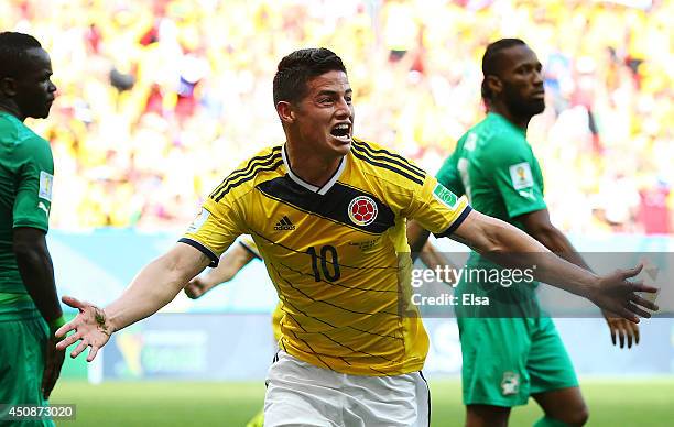 James Rodriguez of Colombia celebrates after scoring his team's first goal during the 2014 FIFA World Cup Brazil Group C match between Colombia and...