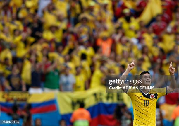 Colombia's midfielder James Rodriguez celebrates after scoring a goal during the Group C football match between Colombia and Ivory Coast at the Mane...