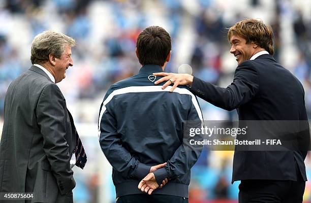 Head coach Roy Hodgson and assistant coach Gary Neville of England greet Diego Lugano of Uruguay prior to the 2014 FIFA World Cup Brazil Group D...