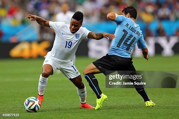 Raheem Sterling of England controls the ball against Nicolas Lodeiro of Uruguay during the 2014 FIFA World Cup Brazil Group D match between Uruguay...