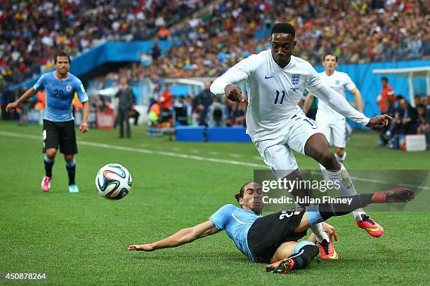 Martin Caceres of Uruguay tackles Danny Welbeck of England during the 2014 FIFA World Cup Brazil Group D match between Uruguay and England at Arena...
