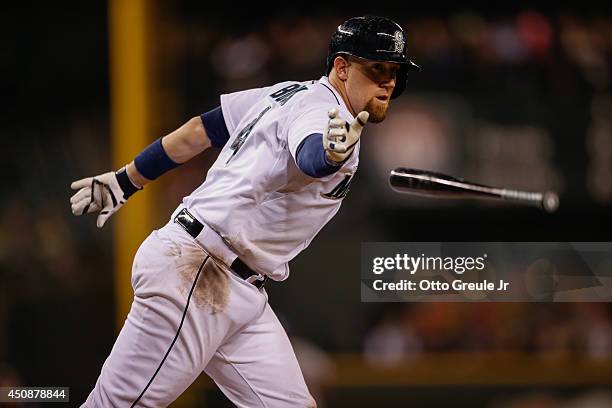 John Buck of the Seattle Mariners tosses his bat as he heads to first after taking what he thought was ball four against the Texas Rangers at Safeco...