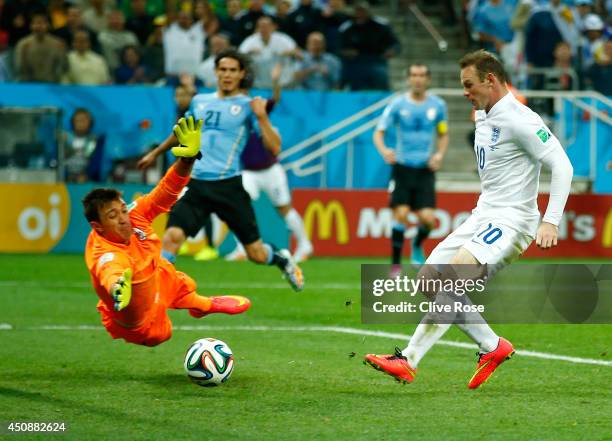 Wayne Rooney of England scores his team's first goal past Fernando Muslera of Uruguay during the 2014 FIFA World Cup Brazil Group D match between...