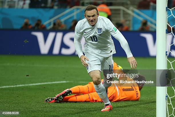 Wayne Rooney of England scores his team's first goal past Fernando Muslera of Uruguay during the 2014 FIFA World Cup Brazil Group D match between...