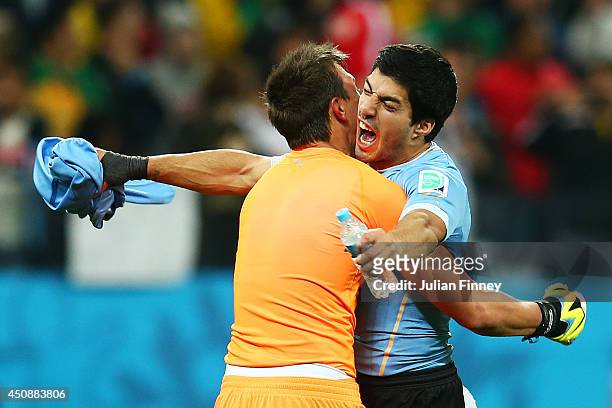 Fernando Muslera of Uruguay hugs Luis Suarez after defeating England 2-1 during the 2014 FIFA World Cup Brazil Group D match between Uruguay and...