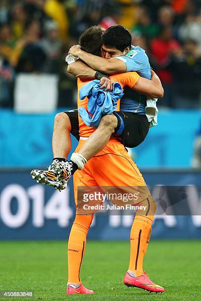 Fernando Muslera of Uruguay hugs Luis Suarez after defeating England 2-1 during the 2014 FIFA World Cup Brazil Group D match between Uruguay and...