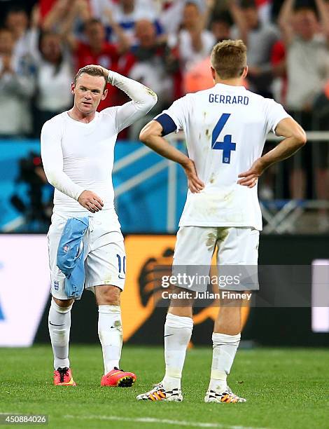 Dejected Wayne Rooney and Steven Gerrard of England look on after being defeated by Uruguay 2-1 during the 2014 FIFA World Cup Brazil Group D match...