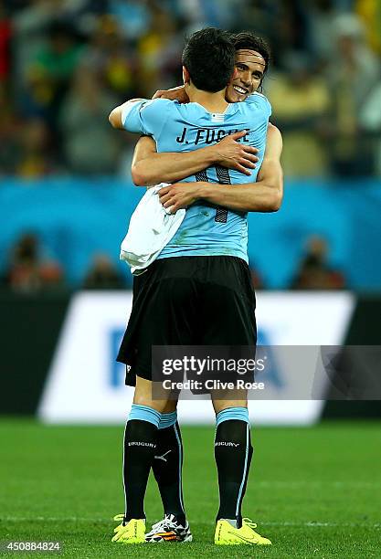 Edinson Cavani of Uruguay hugs teammate Jorge Fucile after defeating England 2-1 during the 2014 FIFA World Cup Brazil Group D match between Uruguay...
