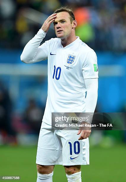 Dejected Wayne Rooney of England looks on after being defeated by Uruguay 2-1 during the 2014 FIFA World Cup Brazil Group D match between Uruguay and...