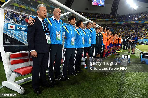 Head coach Alberto Zaccheroni of Japan, team staffs and substitutes line up for the national anthems prior to the 2014 FIFA World Cup Brazil Group C...