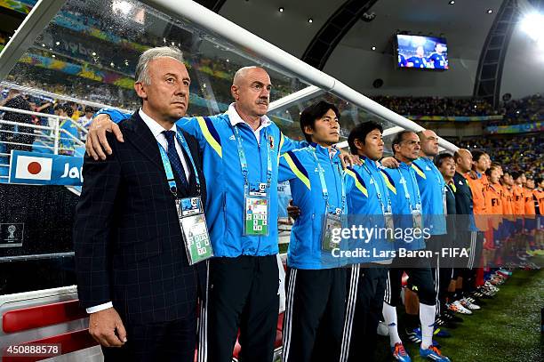 Head coach Alberto Zaccheroni of Japan, team staffs and substitutes line up for the national anthems prior to the 2014 FIFA World Cup Brazil Group C...