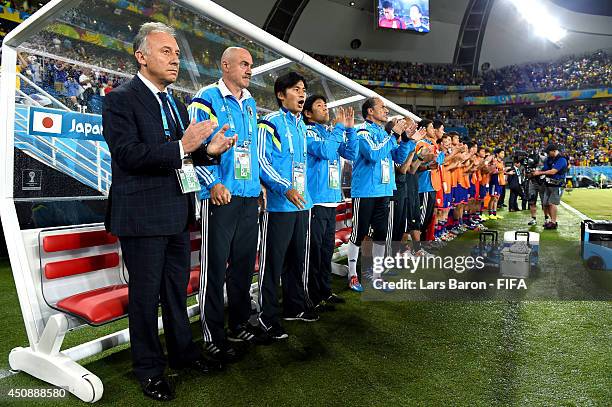 Head coach Alberto Zaccheroni of Japan, team staffs and substitutes line up for the national anthems prior to the 2014 FIFA World Cup Brazil Group C...