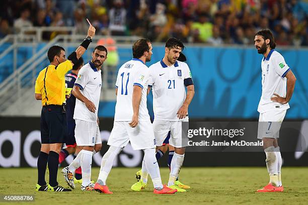 Konstantinos Katsouranis of Greece is shown a red card after receiving his second yellow by referee Joel Aguilar during the 2014 FIFA World Cup...