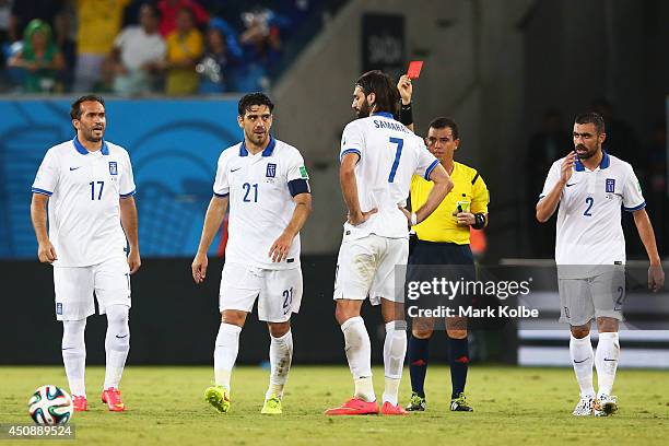 Konstantinos Katsouranis of Greece is shown a red card after receiving his second yellow by referee Joel Aguilar during the 2014 FIFA World Cup...