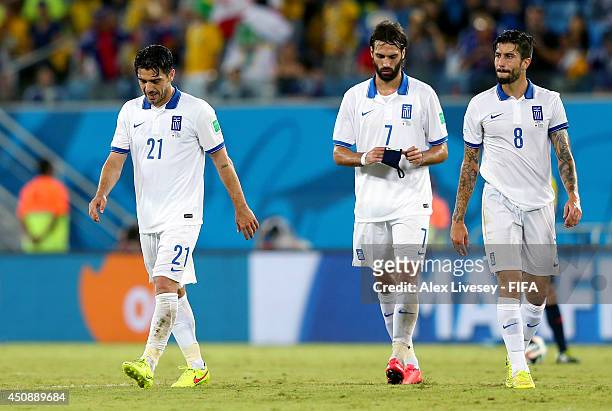 Konstantinos Katsouranis of Greece walks off the pitch after receiving a red card while Giorgos Samaras of Greece is passed the captain's armband...