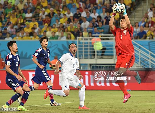 Japan's goalkeeper Eiji Kawashima makes a save during a Group C match between Japan and Greece at the Dunas Arena in Natal during the 2014 FIFA World...