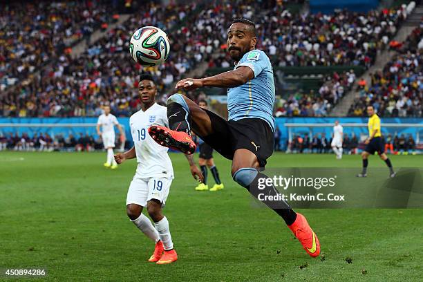 Alvaro Pereira of Uruguay controls the ball as Raheem Sterling of England looks on during the 2014 FIFA World Cup Brazil Group D match between...